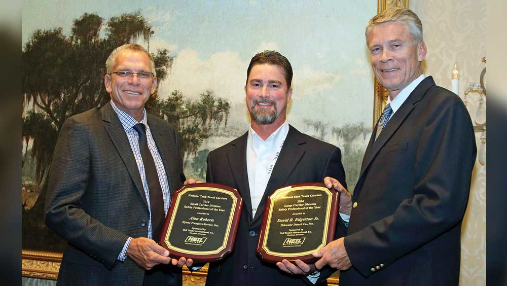 Alan Roberts left Wynne Transport Service Inc safety director accepts a plaque naming him Tank Truck Safety Professional of the Year for fleets under 15 million miles and David Edgerton right receives a plaque honoring him as Tank Truck Safety Professional of the Year for fleets above 15 million miles The awards were sponsored by Heil Trailer International and were presented by Troy Hradsky with Heil Trailer International