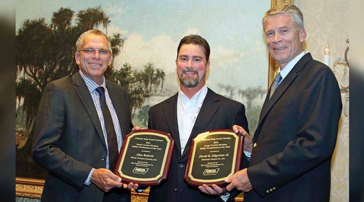 Alan Roberts [left], Wynne Transport Service Inc safety director accepts a plaque naming him Tank Truck Safety Professional of the Year for fleets under 15 million miles and David Edgerton [right] receives a plaque honoring him as Tank Truck Safety Professional of the Year for fleets above 15 million miles. The awards were sponsored by Heil Trailer International and were presented by Troy Hradsky with Heil Trailer International.