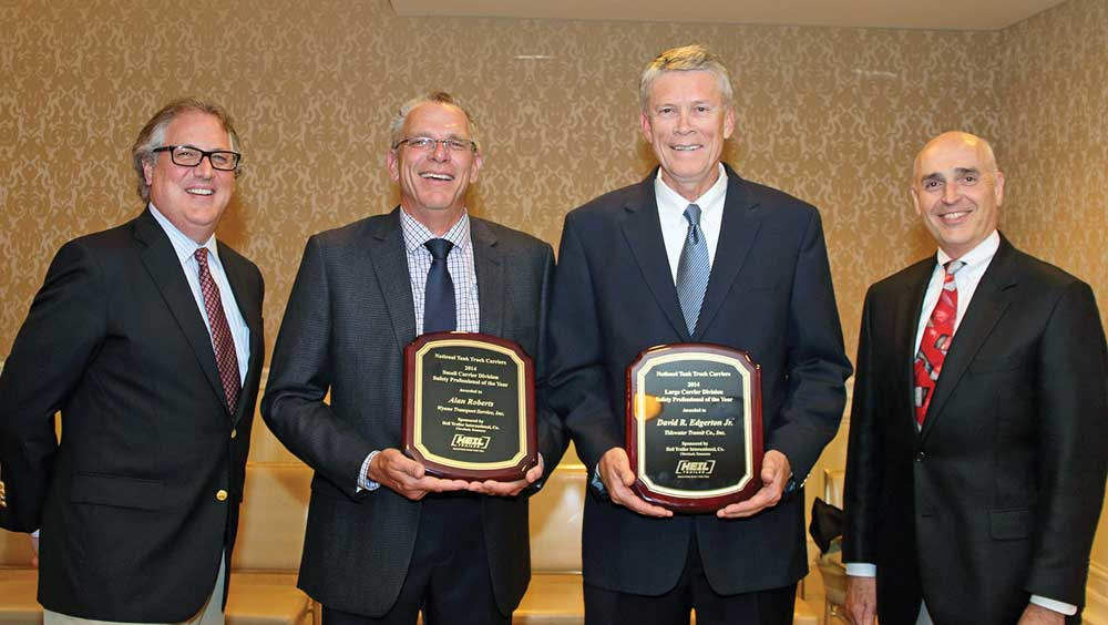 Alan Roberts center left Wynne Transport Service and David Edgerton center right Tidewater Transit Inc are congratulated on being named Tank Truck Safety Professionals of the Year by Dan Furth far left NTTC president and Paul Baumgardner far right FMCSA