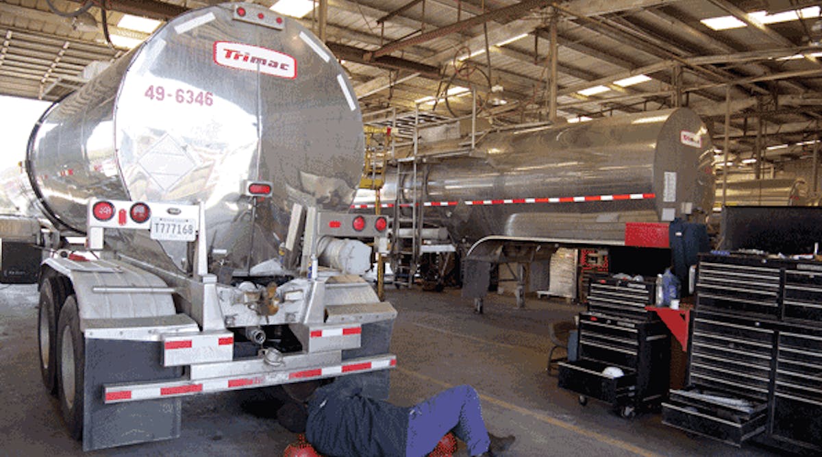 A mechanic works on the brakes on this tank trailer. Good brake maintenance is critical to tank fleet safety.