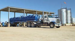 A vacuum fleet operator offloads process water from an oil well at Fortress Environmental&rsquo;s four-bay salt water disposal facility in Waelder TX. In addition to water disposal, the 15-acre facility offers a wide variety of oilfield support services.