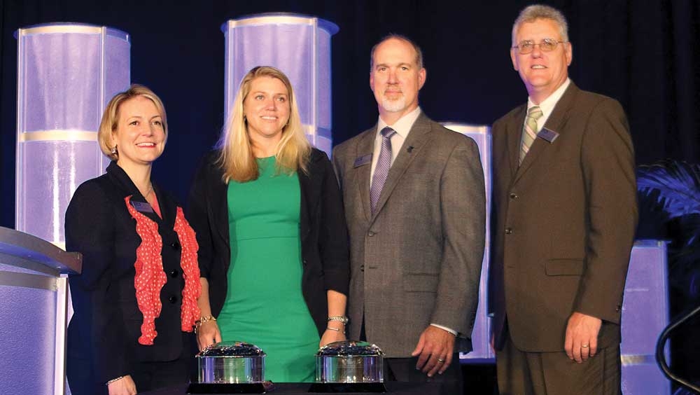ILTArsquos far left President Melinda Whitney and Vice President of Government Affairs Peter Lidiak far right present the 2017 Platinum Award for a small company to Jackie Alf and Eric Thomas of Benchmark River and Rail Terminals