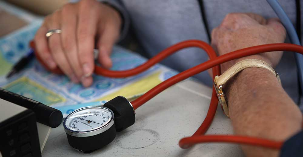 Closeup of nurse taking blood pressure