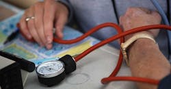 Closeup of nurse taking blood pressure Closeup of nurse taking blood pressure