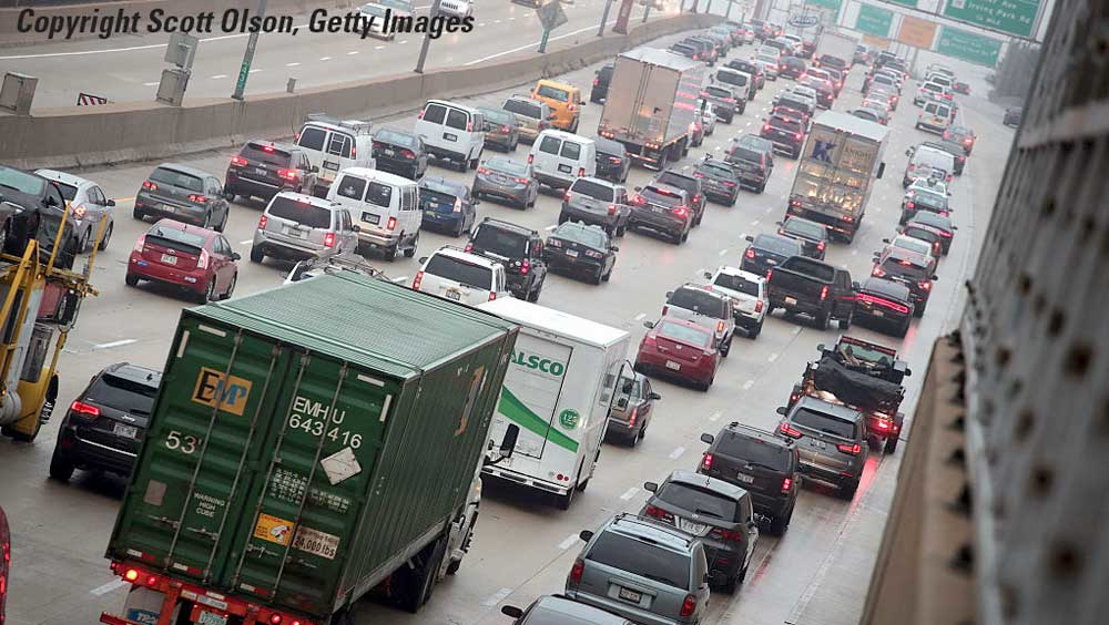 Freeway congestion from overhead taillights commercial truck in foreground