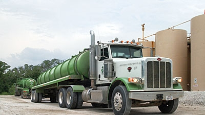 Two vacuum transports in the Green Energy Oilfield Services LLC fleet offload process water at an injection well in central northeast Texas A new oilfield operator Green Energy grabbed headlines earlier this year by putting one of the largest LNGfueled truck fleets into oilfield operations The Fairfield TX company is running 60 LNGfueled Peterbilt Model 388s in Texasrsquo Freestone Trend WoodbineEaglebine and Eagle Ford shale plays