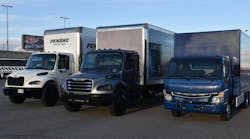 A pair of Freightliner eM2s and a Fuso eCanter were on hand for transportation editors to test drive at the Las Vegas Motor Speedway.