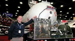 Jason Cornell stands with one of J&amp;J Truck Bodies&rsquo; new propane bobtails that were displayed for the first time at MATS. The company currently is assembling two bobtails a week. The bobtails come standard with open decks.