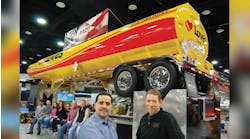 Pictured with the brightly painted show trailer at right foreground are Ed Mansell, vice-president of MAC Liquid Tank Trailers and Jim Maiorana, president. Seated at left are some of the workers at the Kent and Billings plants who attended the Mid-America Trucking Show. (sales@macltt.com)