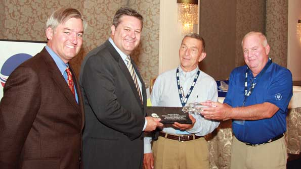 Hans Schaupp left LCL Bulk Transport Inc and newly elected NTTC chairman and David Parker and Dick Lehr Great West Casualty present a crystal tank truck on a marble base to Greg Hodgen Groendyke Transport Inc in appreciation of Hodgenrsquos service as the 20112012 NTTC chairman
