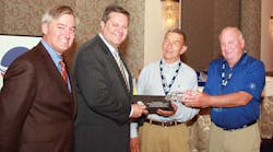 Hans Schaupp [left], LCL Bulk Transport Inc and newly elected NTTC chairman, and David Parker and Dick Lehr, Great West Casualty, present a crystal tank truck on a marble base to Greg Hodgen, Groendyke Transport Inc, in appreciation of Hodgen&rsquo;s service as the 2011-2012 NTTC chairman.