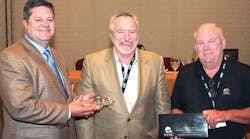 Greg Hodgen [left], Groendyke Transport and newly elected NTTC chairman, and Dick Lehr [right], Great West Casualty, present a crystal tank truck on a marble base to Steve Rush, Carbon Express Inc, in appreciation for Rush&rsquo;s service as the 2010-2011 NTTC chairman.