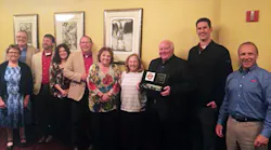 Heil Trailer presents the Werts Welding team with plaque commemorating 60th