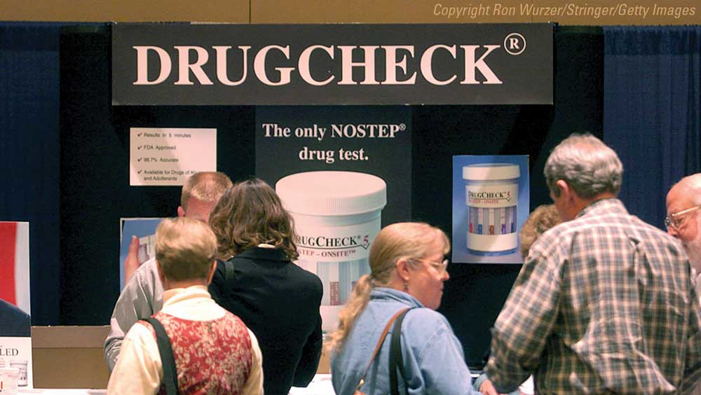 Visitors at the DrugCheck booth in exhibition hall