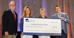 Dan Furth (from left), NTTC; Candi Coate, K-Limited Carrier; Barbara Herman, 2018-2019 NTTC Professional Tank Truck Driver of the Year; and Bernie Gorski, NTTC Chairman; hold up an enlarged version of a check for the donation NTTC made on Herman&rsquo;s behalf to Leading Families Home.