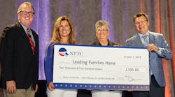 Dan Furth (from left), NTTC; Candi Coate, K-Limited Carrier; Barbara Herman, 2018-2019 NTTC Professional Tank Truck Driver of the Year; and Bernie Gorski, NTTC Chairman; hold up an enlarged version of a check for the donation NTTC made on Herman&rsquo;s behalf to Leading Families Home.
