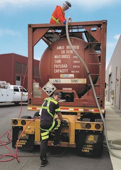 LTI, Inc. driver Glenn Manning, at top, and mechanic Tyler Manke unload a tank of chlorine for treating the water supply in Anacortes, Wash.