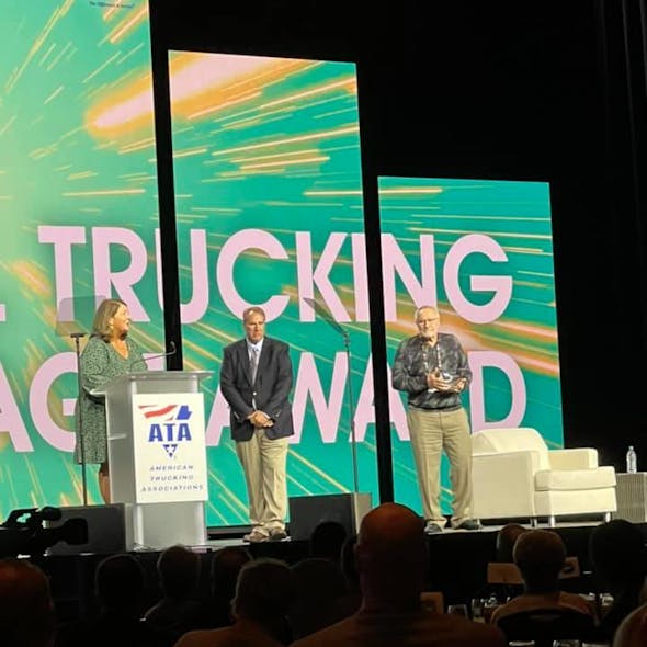Carbon Express president Steve Rush, at right, accepts a 2021 Mike Russell Trucking Image Award for his company&apos;s efforts to improve truck drivers&apos; quality of life.