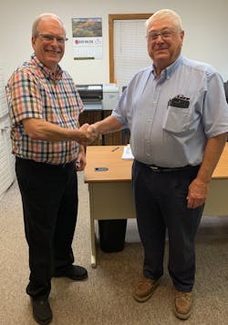 Crystal Flash president and CEO Tom Olive, at left, shakes hands with JMT founder Barry Jacobson. Crystal Flash president and CEO Tom Olive, at left, shakes hands with JMT founder Barry Jacobson.