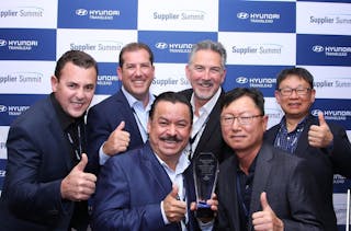 Phillips Industries&apos; OEM division recently received a 2021 Supplier Excellence Award from Hyundai Translead. Pictured up front are Filiberto Coello, Phillips OEM division president, at left, and Bongjae Lee, Hyundai Translead CEO. In the back row, from left to right, are Phillips OEM director of operations Jorge Gonzalez, Phillips EVP Dave Phillips, Phillips OEM senior sales director Ron Alvarez, and Hyundai Translead procurement VP Walter Kim.