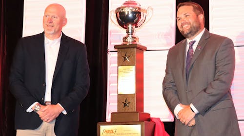 Service Transport Company president Wade Harrison, at left, and Engineered Transportation International CEO Ryan Rockafellow pose with the Harvison division Heil Trophy on Tuesday during the 2022 NTTC Annual Conference in San Diego, Calif.