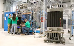 Employees at Plug Power&apos;s Rochester-area gigafactory assemble an electrolyzer, the key machinery that converts water in hydrogen and oxygen.
