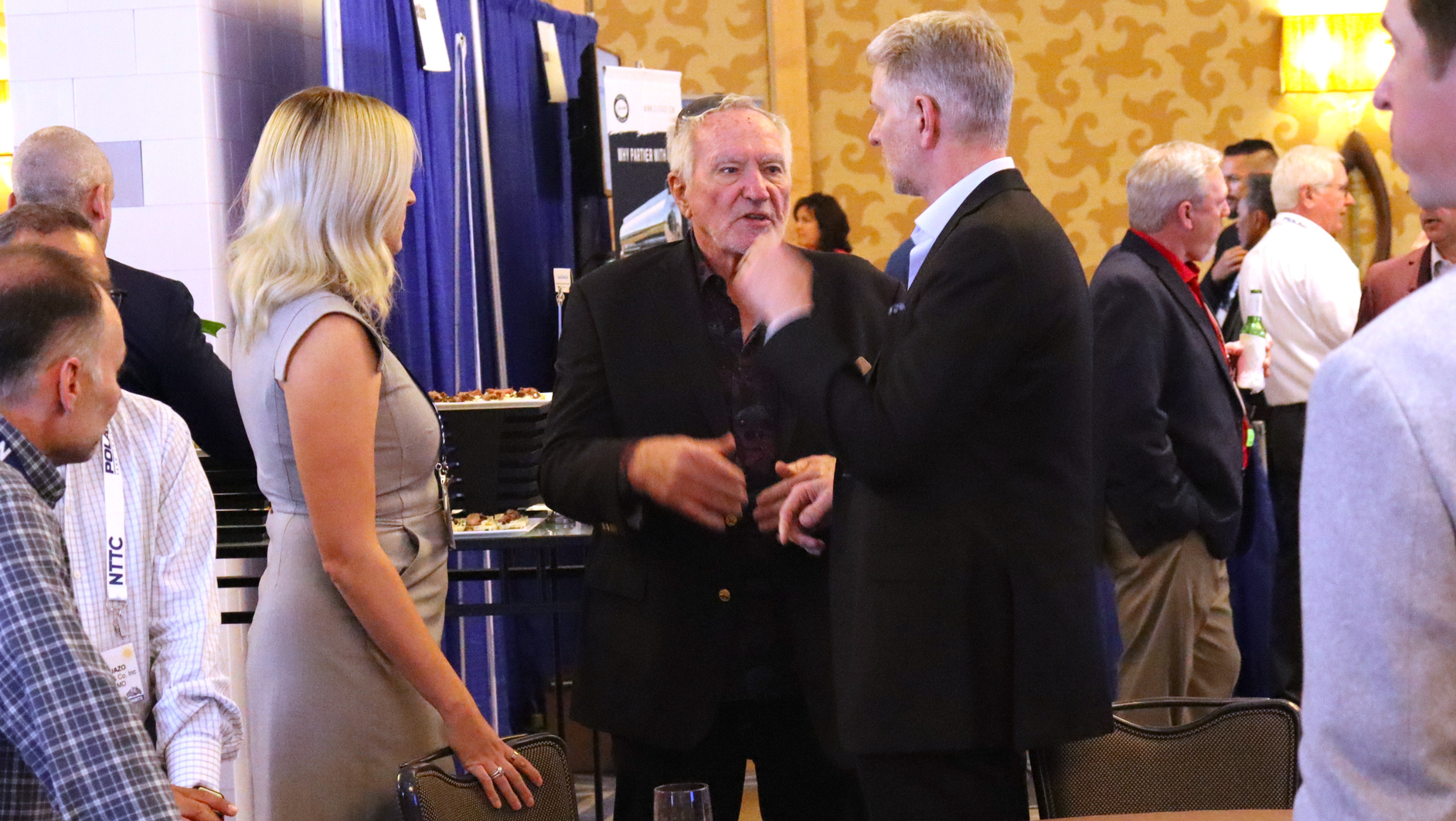 Carbon Express founder Steve Rush, center, talks to Darron Eschle, Andrews Logistics chairman and CEO, at right, during the 2022 National Tank Truck Carriers Annual Conference in San Diego, Calif.