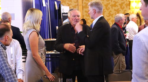 Carbon Express founder Steve Rush, center, talks to Darron Eschle, Andrews Logistics chairman and CEO, at right, during the 2022 National Tank Truck Carriers Annual Conference in San Diego, Calif.