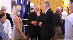 Carbon Express founder Steve Rush, center, talks to Darron Eschle, Andrews Logistics chairman and CEO, at right, during the 2022 National Tank Truck Carriers Annual Conference in San Diego, Calif.