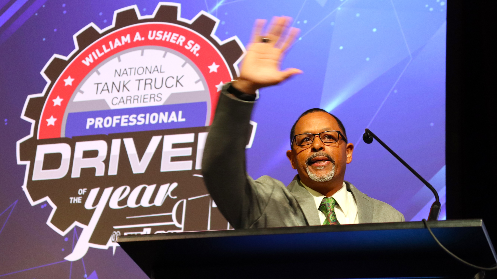 Hoffman Transportation driver Kenneth Tolliver waves to the crowd after earning the title of NTTC's 2022-23 Professional Tank Truck Driver of the Year on May 22 in Everett, Massachusetts.