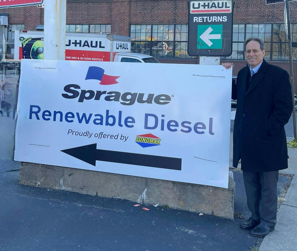 Steven Levy, Sprague managing director of new business development, stands in front of Sonomax&rsquo;s sign promoting New York&rsquo;s first public renewable diesel station.