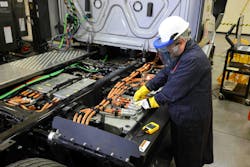 A technician works on a Freightliner eCascadia, Daimler Truck North America&apos;s heavy-duty battery-electric vehicle. The OEM is rolling out a BEV dealer certification program that it expects to be operating at 100 dealer locations by 2025.