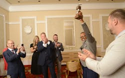 Kenneth Tolliver hoists the prestigious William A. Usher Sr. championship trophy in celebration alongside G&amp;D Trucking/Hoffman Transportation leaders after winning NTTC&apos;s 2022-23 Professional Tank Truck Driver of the Year award.