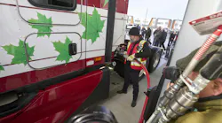 A Mullen Group driver demonstrates how to fuel up with CNG at the new Tourmaline and Clean Energy CNG station in Calgary, Alberta, Canada.
