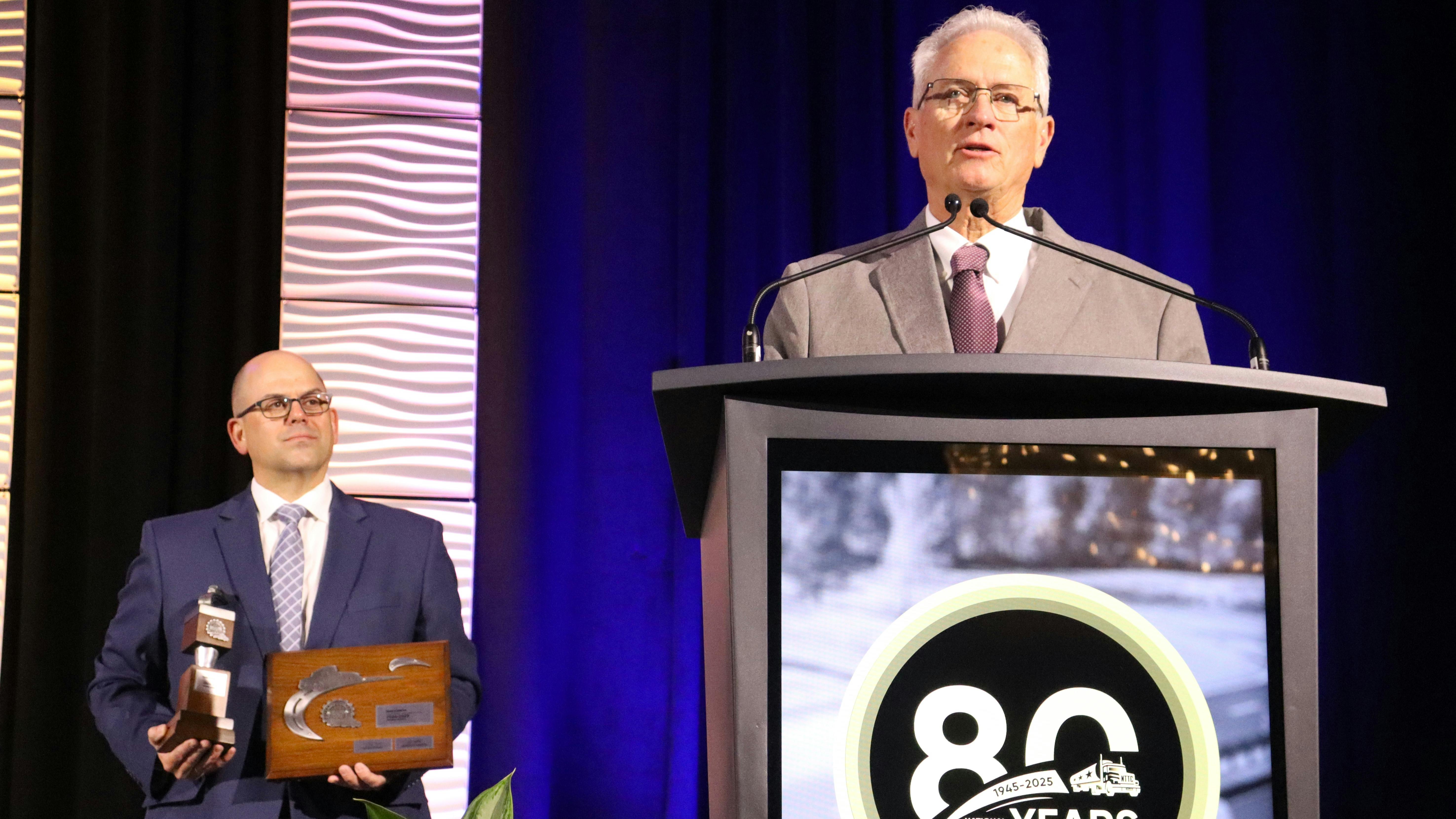 Mark Schroyer addresses the gathered crowd as NTTC President and CEO Ryan Streblow looks on.