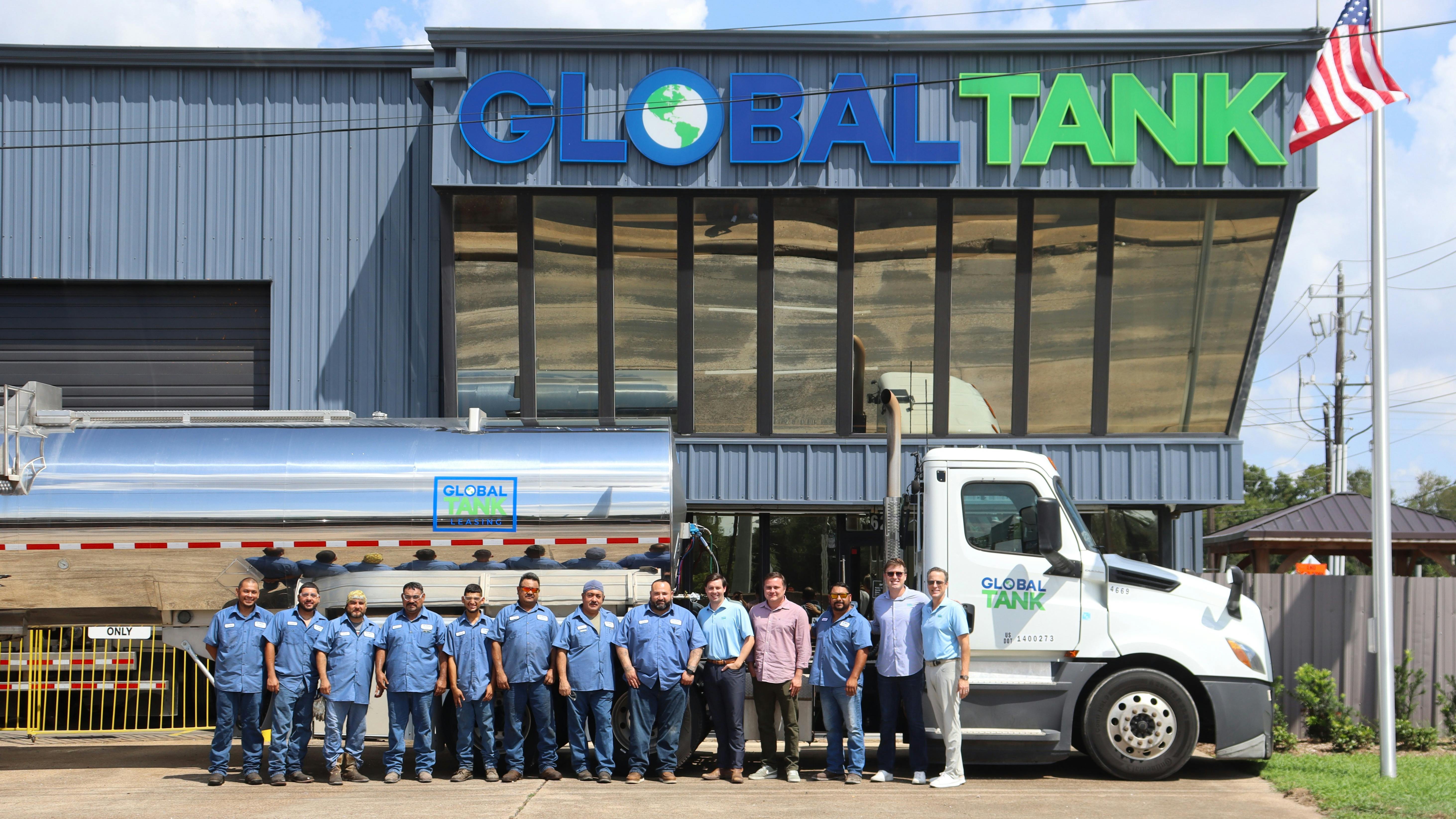 From right to left, Global Tank President James Stinson, Leasing Director Grant Stinson, and their Pasadena staff stand in front of a Wabash chemical tank trailer pulled by a Freightliner Cascadia truck. Global Tank opened a second Houston-area location in October.