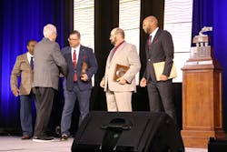 Mark Schroyer, NTTC’s 2024-25 Professional Tank Truck Driver of the Year, shakes hands with fellow finalists—including returning finalists Bruce Jones of G&D/Hoffman and Michael Key of KAG—after claiming the Usher trophy at the 2026 NTTC Annual Conference in Tampa, Florida. Mark Schroyer, NTTC’s 2024-25 Professional Tank Truck Driver of the Year, shakes hands with fellow finalists—including returning finalists Bruce Jones of G&D/Hoffman and Michael Key of KAG—after claiming the Usher trophy at the 2026 NTTC Annual Conference in Tampa, Florida.