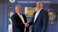 Bud Dungan, founder and CEO of Gastronics, at left, shakes hands with Kevin McKeigue, Safe Monitoring Group Americas president.