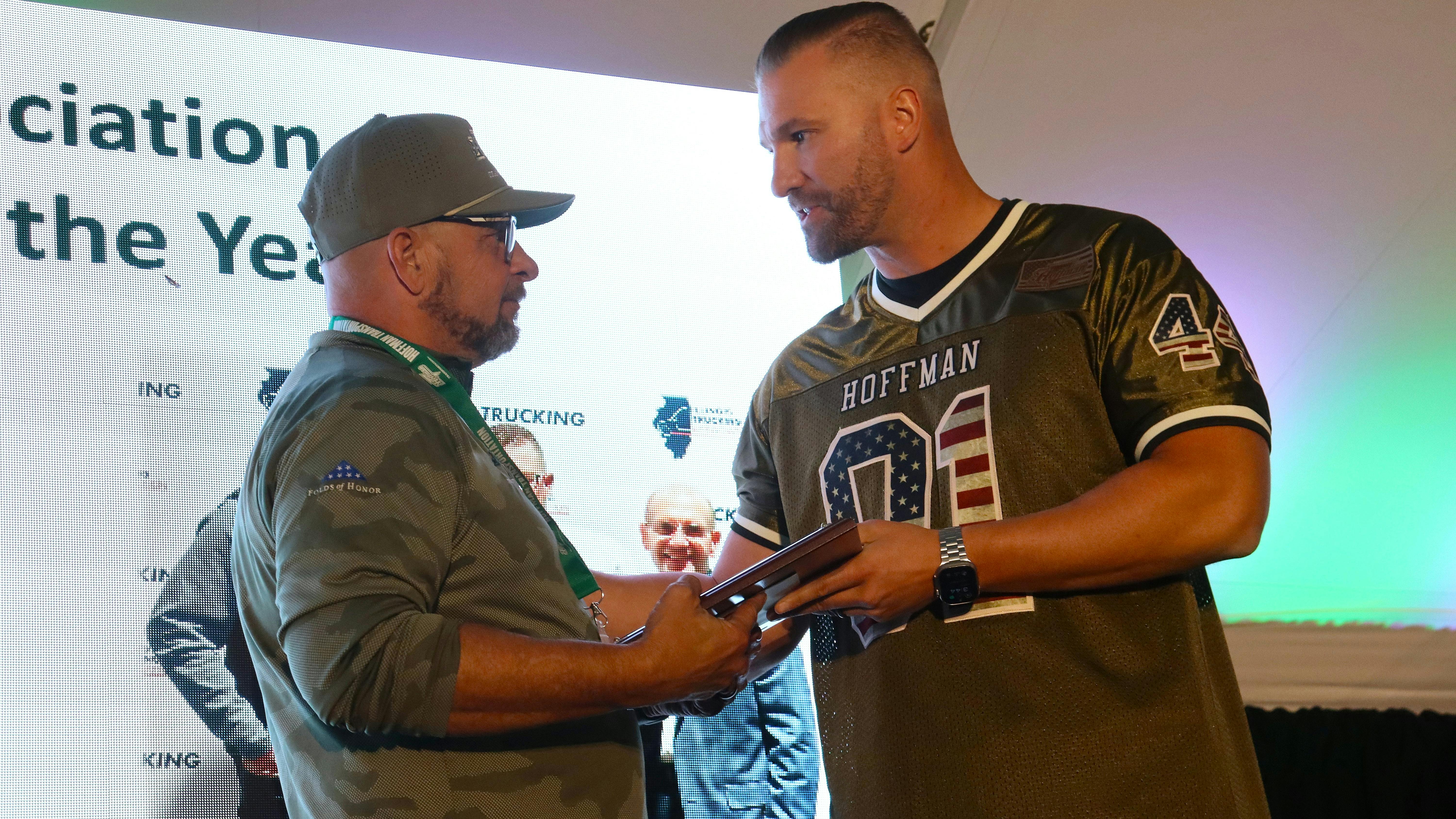 G&D Trucking/Hoffman Transportation Vice President Jordan Hoffman, at right, congratulates Bruce Jones for earning the Illinois Trucking Association's 2024 Driver of the Year award last year at G&D/Hoffman's annual employee appreciation event.