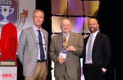 John Conley, past NTTC president and Bulk Transporter editor, accepts a Distinguished Service Award while flanked by past chairman Herb Evans, at left, and outgoing NTTC chair David Price.