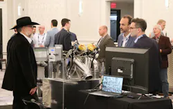John LaGrand, BTI's AutoLoad national accounts manager, at left, introduces the AutoLoad system to interested visitors during the 2025 NTTC Annual Conference in Tampa, Fla.