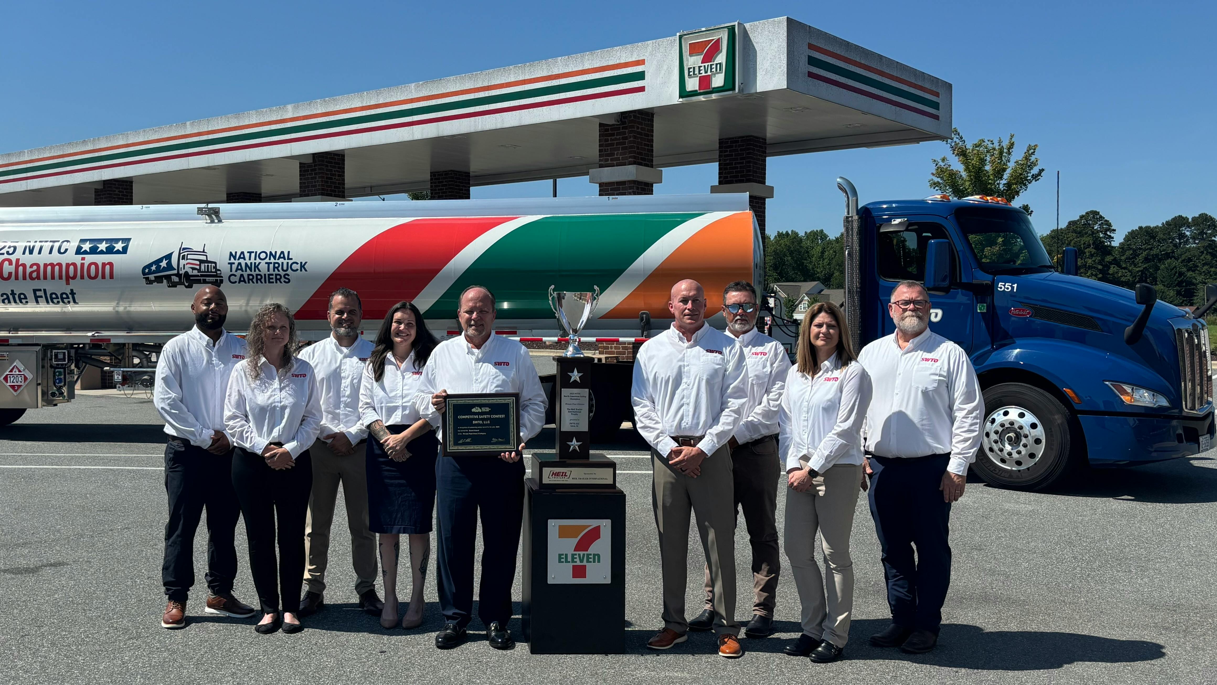 The SWTO team proudly displays the private fleet's championship hardware in front of a specially wrapped tank trailer.