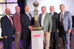 The Heniff team gathers around their newly secured Heil trophy while flanked by NTTC President and CEO Ryan Streblow, at left, and EnTrans International President and CEO Jake Radish, at right, during the 2026 NTTC Annual Conference in Baltimore, Maryland.