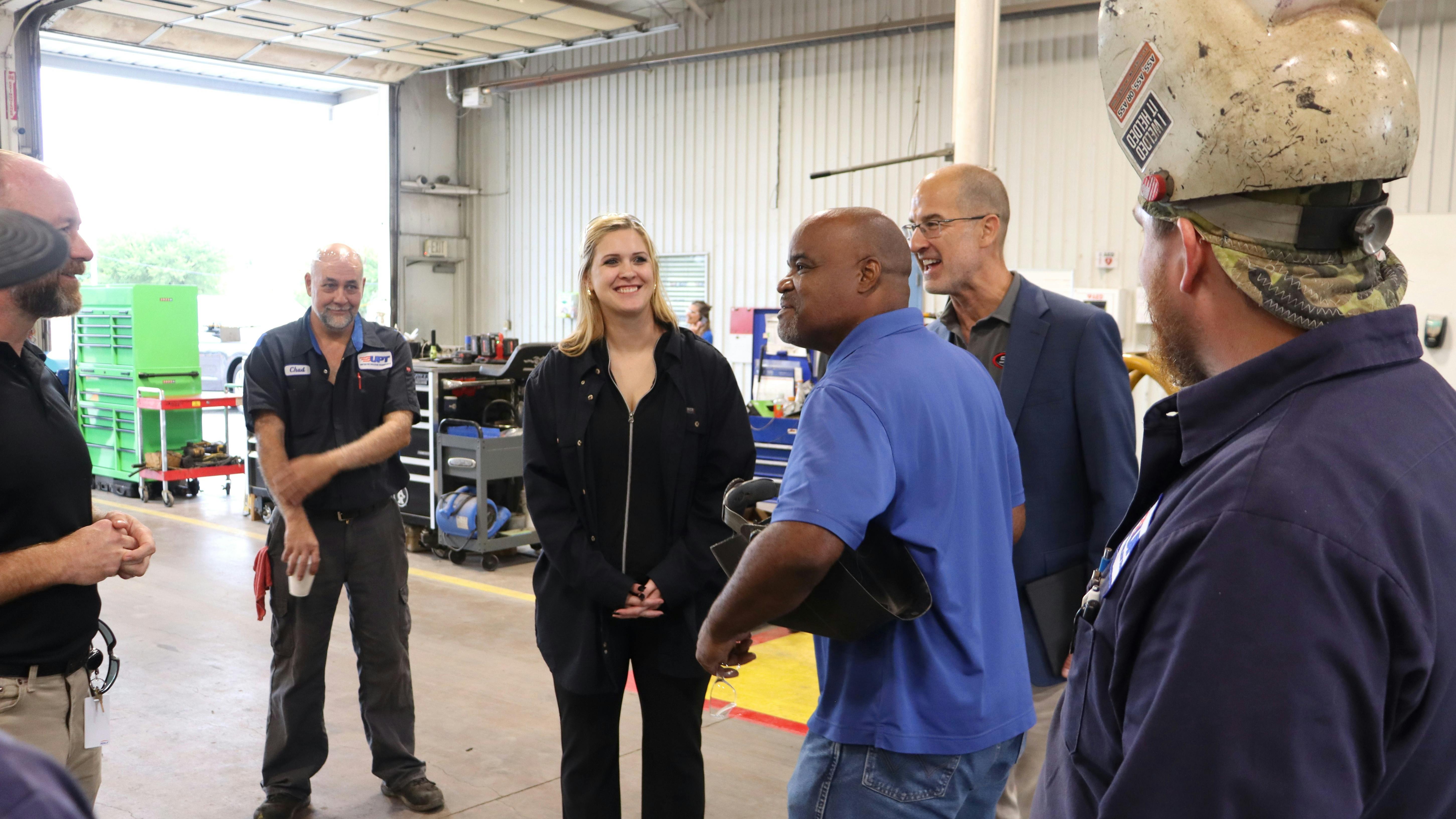 STE inside sales representative Paige Cushing (center) smiles as UPT&rsquo;s veteran maintenance crew realizes they&rsquo;ve been &ldquo;Punk&rsquo;d.&rdquo; Her surprise shop visit served as a lighthearted finale to a major milestone week for UPT, which celebrated its 60th anniversary in Oklahoma City by hosting an open house at its new downtown headquarters and showcasing custom STE tank trailers at Tank Truck Week 2026.