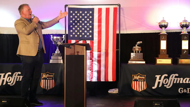 Legendary singer Jim Cornelison delivers a surprise, rousing performance of the national anthem alongside G&D/Hoffman&rsquo;s collection of national safety trophies. When severe weather grounded scheduled guest speakers at the 17th annual employee appreciation event, company leaders executed a flawless pivot to save the massive celebration, perfectly reflecting the event&rsquo;s &ldquo;hold the line&rdquo; theme of meeting unexpected challenges proactively.